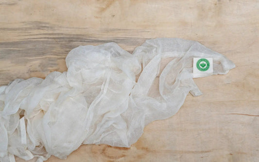 Cotton cheesecloth from Organic Cotton Mart, white sheer kitchen fabric with green label on wood on Tampa Home & Garden Store