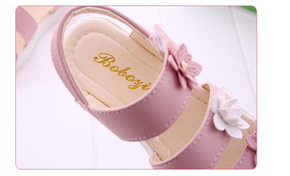 Pink children's sandals with flower straps and bows, open toe, beige insole with gold logo on Tampa Home & Garden Store