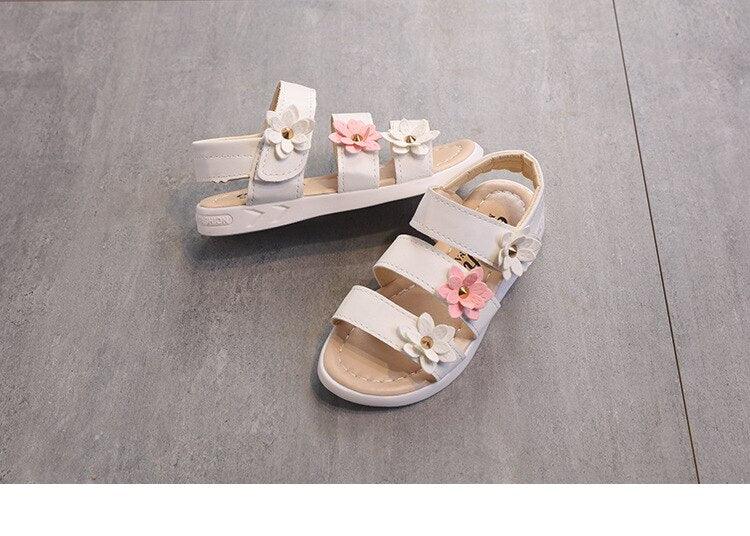 Stevvex girls flower sandals pair with open toes, white straps and pink flower accents on Tampa Home & Garden Store