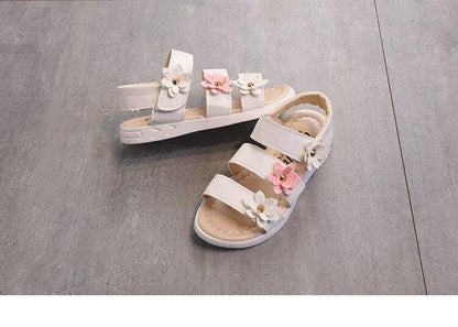 Stevvex girls flower sandals pair with open toes, white straps and pink flower accents on Tampa Home & Garden Store