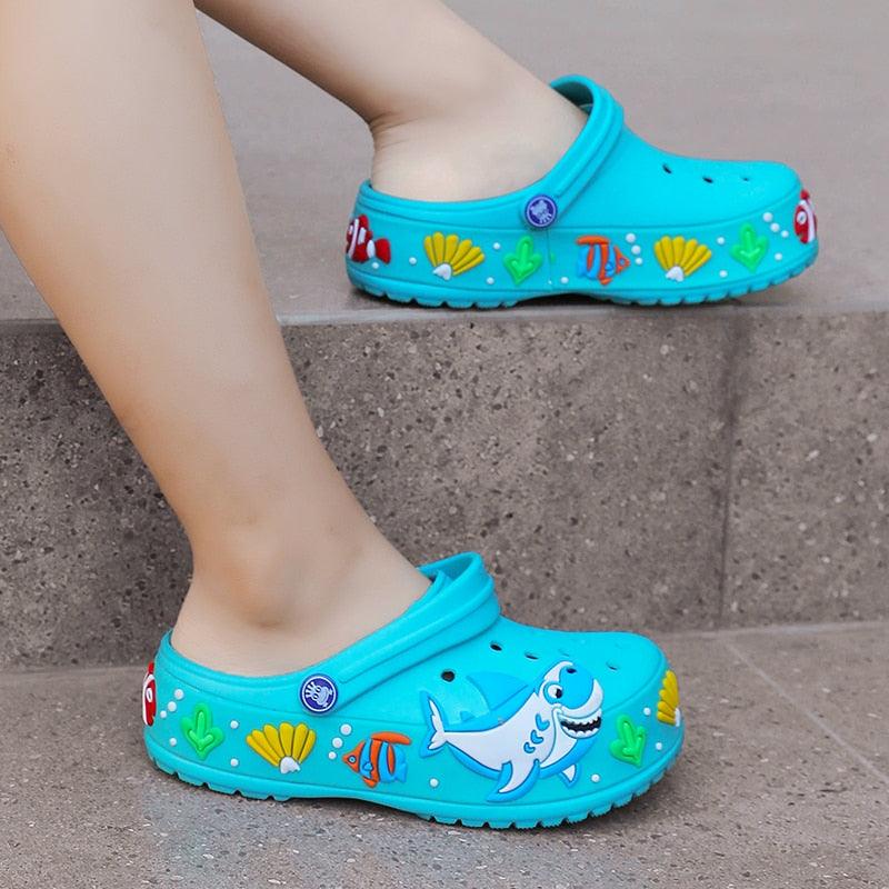 Stevvex children's aqua blue slippers pair Slip-on garden sandals with shark and seashell decals on Tampa Home & Garden Store