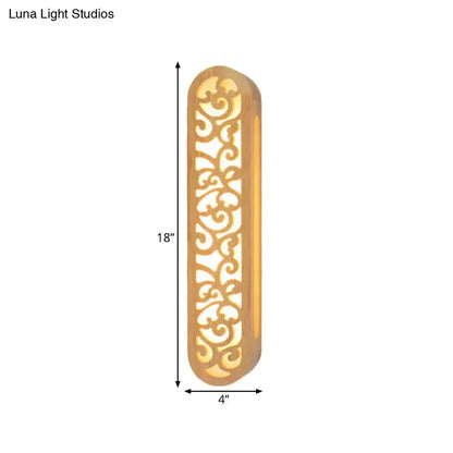 Beige Chinese style carved wood wall sconce, 18in tall by 4in wide with ornate scrollwork on Tampa Home & Garden Store