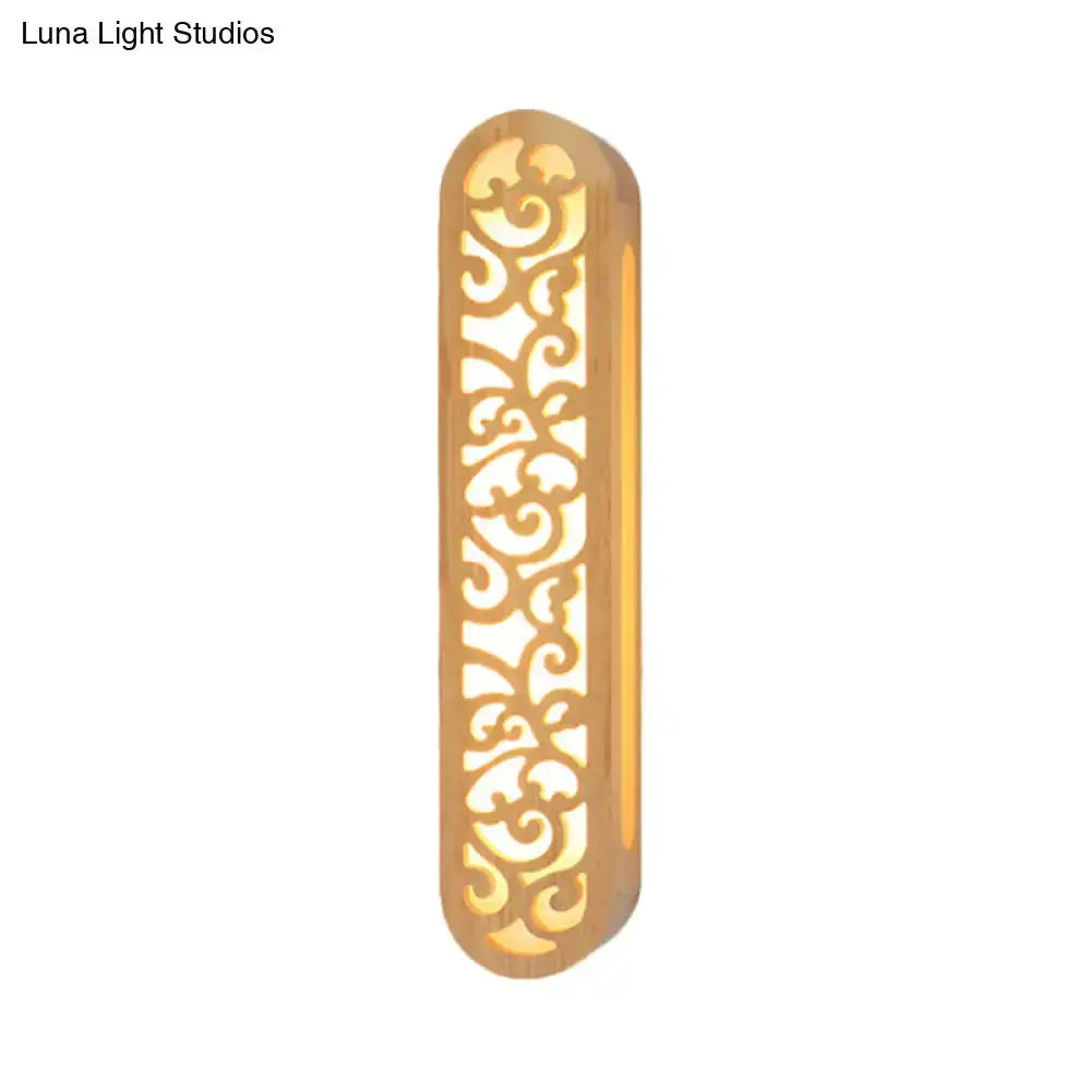 Decorbites beige carved wood wall sconce with Chinese-style scrollwork, warm light on Tampa Home & Garden Store