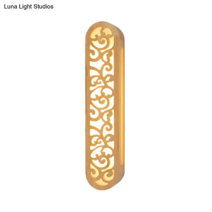 Decorbites beige carved wood wall sconce with Chinese-style scrollwork, warm light on Tampa Home & Garden Store
