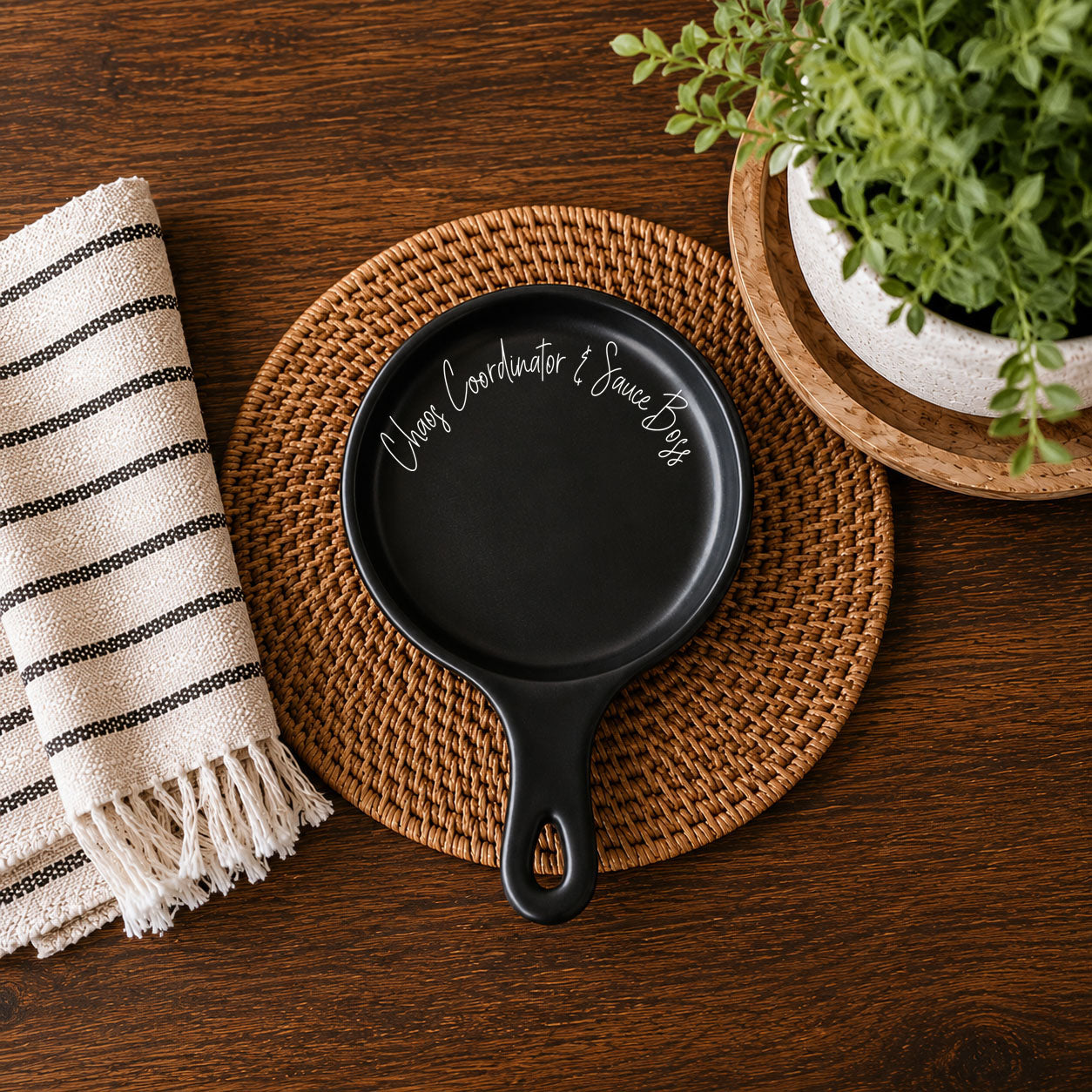 Chaos Coordinator & Sauce Boss spoon rest by Gia Roma, black finish on woven placemat on Tampa Home & Garden Store