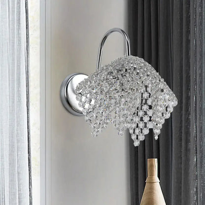 Chrome Crystal Bedroom Glow Wall Sconce by Decorbites with curved arm and hanging prisms on Tampa Home & Garden Store