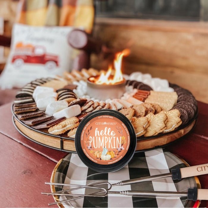 City Bonfires Hello Pumpkin candle on a fall outdoor board with a small fire pit and snacks on Tampa Home & Garden Store