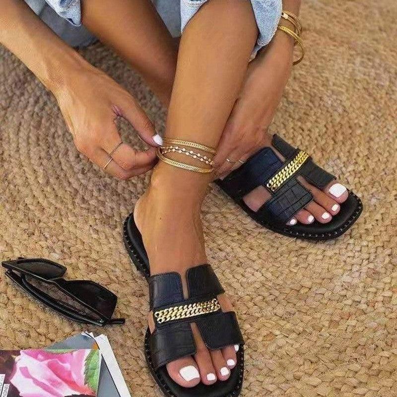 Stevvex black double-chain flat sandals with gold chain strap on feet on Tampa Home & Garden Store