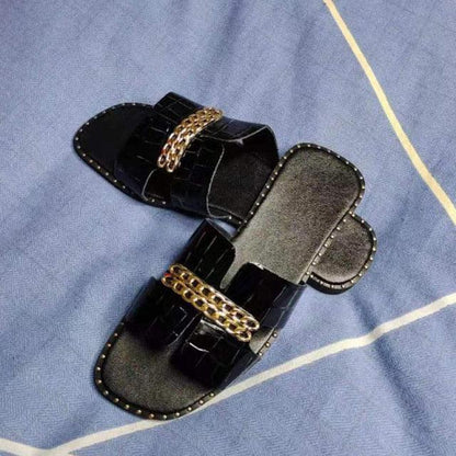 Women’s black flat sandals with gold double-chain straps Stevvex pair on Tampa Home & Garden Store