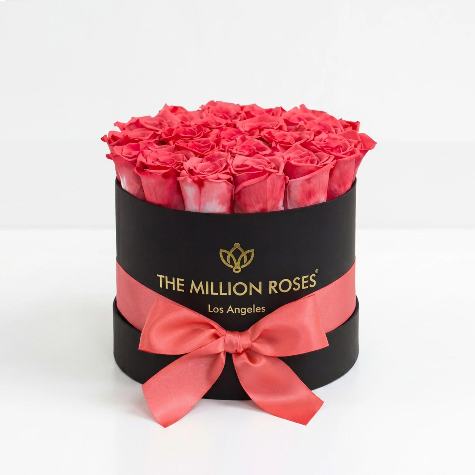 Classic black gift box filled with coral roses and a pink satin ribbon by The Million Roses on Tampa Home & Garden Store