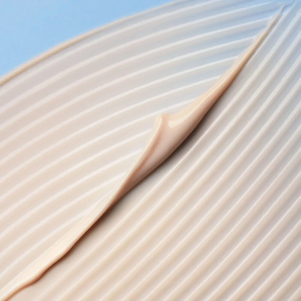 Cle De Peau UV Protective Cream SPF 50+ by Nava Beauty swatch in beige on textured surface on Tampa Home & Garden Store