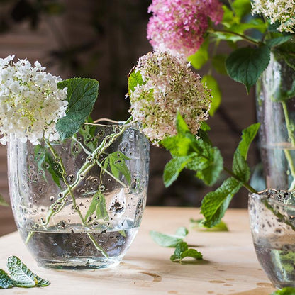 Clear art glass vase by RusticReach with hydrangea stems in water on Tampa Home & Garden Store