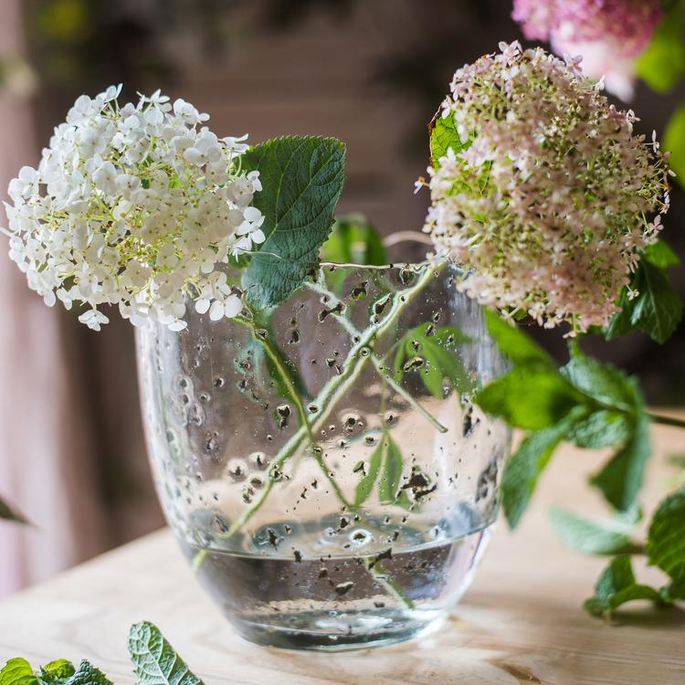 Clear art glass vase by RusticReach with two hydrangea blooms and water, air-bubble glass texture on Tampa Home & Garden Store