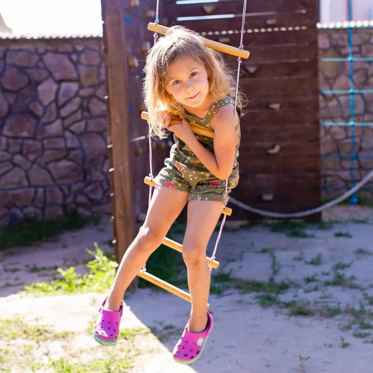 Climbing rope ladder by Goodevas for kids 3-9 on a single swing; girl in green floral outfit on Tampa Home & Garden Store
