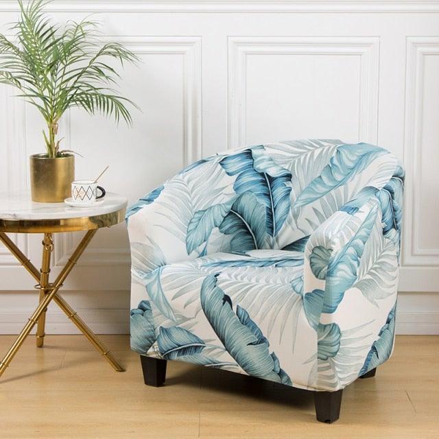 Club chair slipcover in blue tropical leaf print on white fabric; elastic fit on Tampa Home & Garden Store