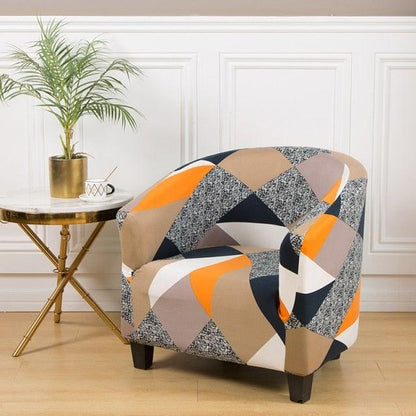 Geometric printed club chair slipcover in orange tan and navy; elastic spandex fit on armchair on Tampa Home & Garden Store