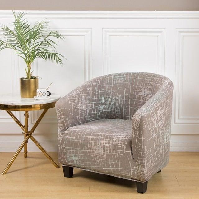 Geometric printed armchair slipcover on a small club chair in a neutral living room on Tampa Home & Garden Store