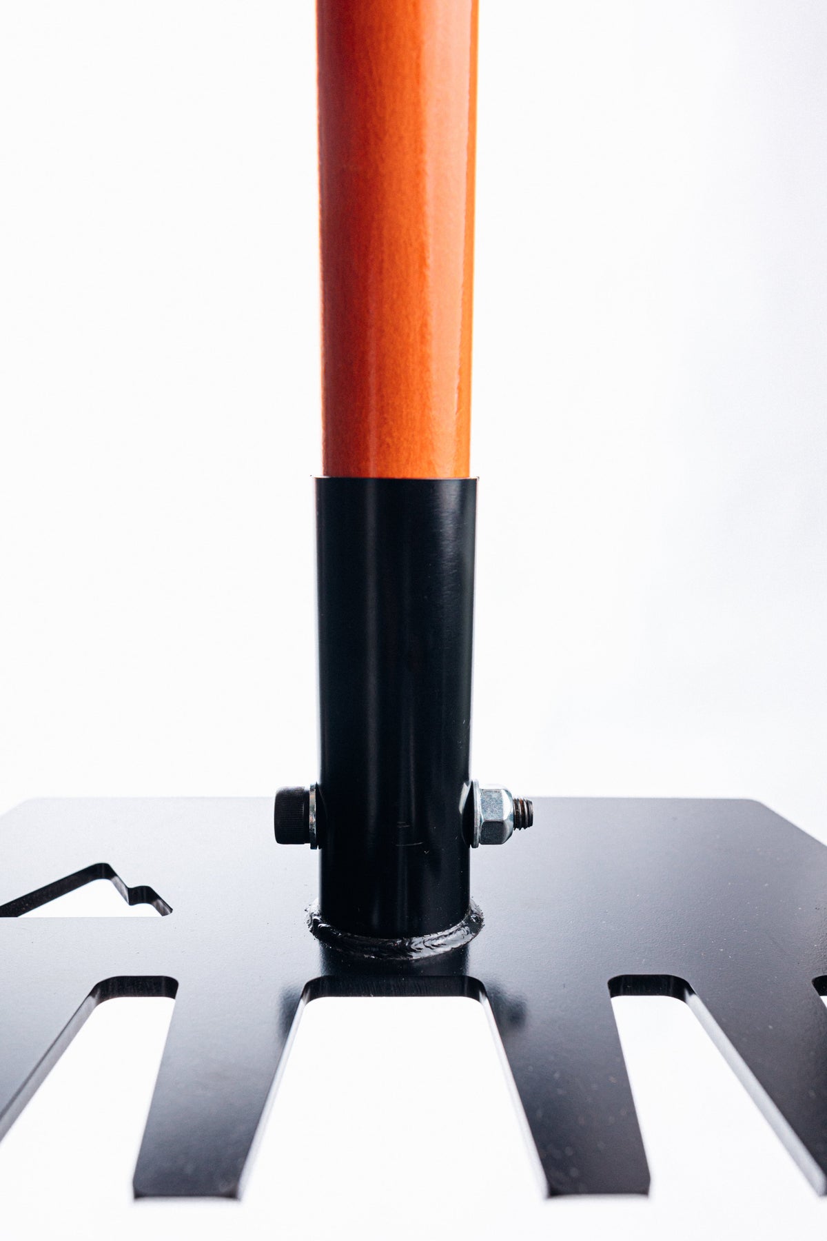 Clyde Pro rake handle in bright orange attached to black metal mounting post with bolts on Tampa Home & Garden Store