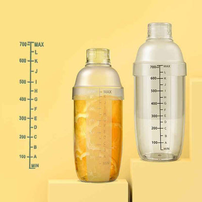 Two Shaketea plastic cocktail shakers with measurement marks and lemon-filled bottle on Tampa Home & Garden Store