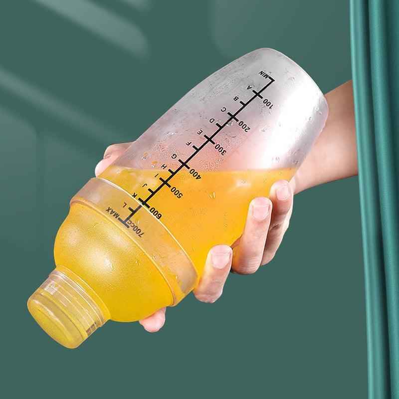 Cocktail shaker Shaketea, clear plastic with ergonomic grip and marks, yellow juice visible on Tampa Home & Garden Store