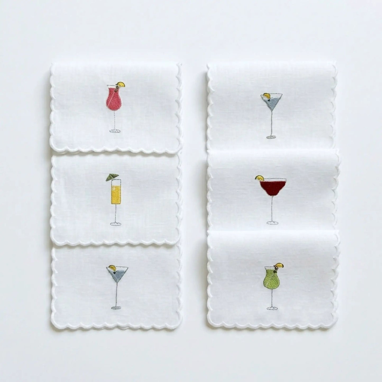 Embroidered cocktail napkins set of six, white with scalloped edges and colorful drink motifs on Tampa Home & Garden Store