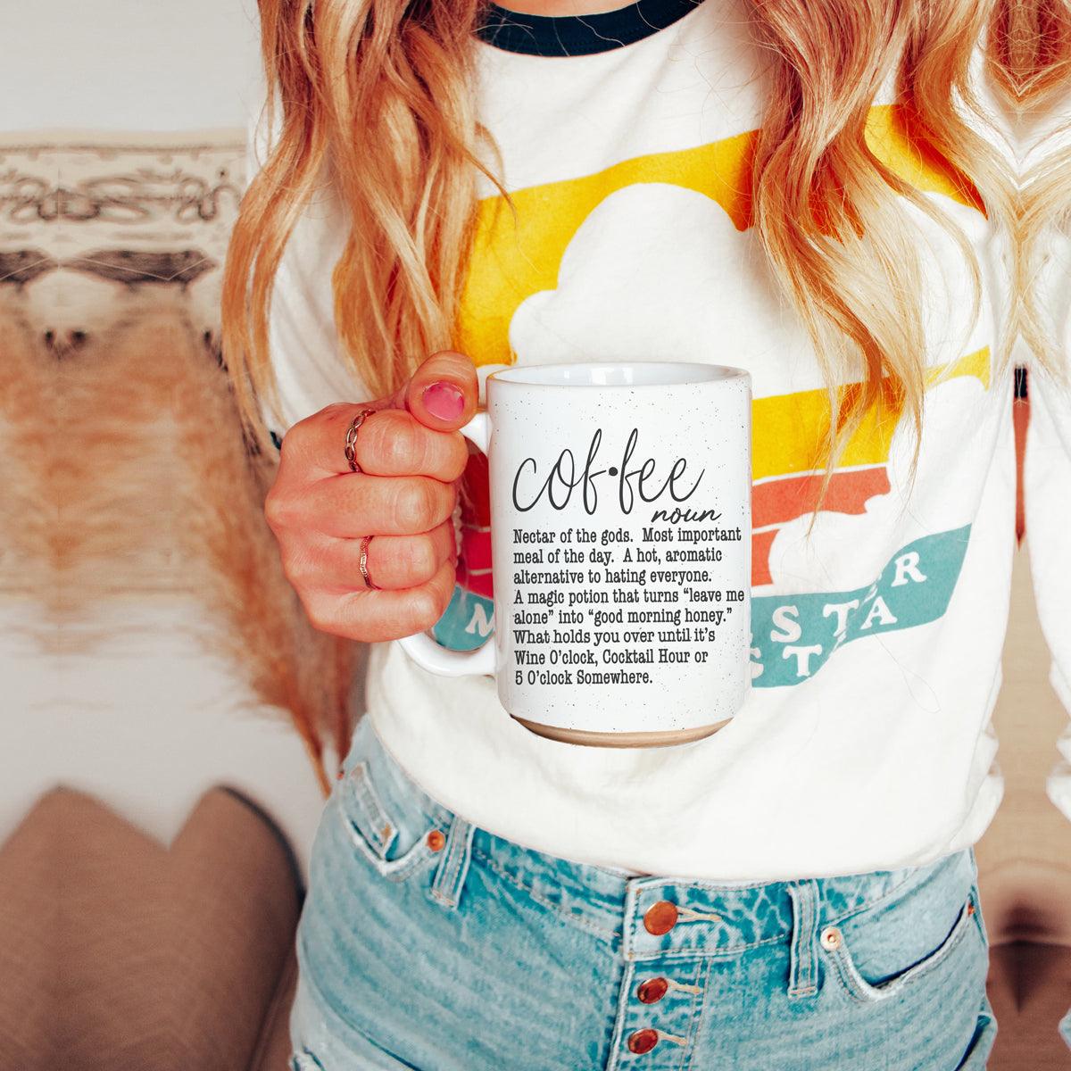 Coffee Def 16oz mug white ceramic with black coffee text held by a woman in a colorful tee on Tampa Home & Garden Store