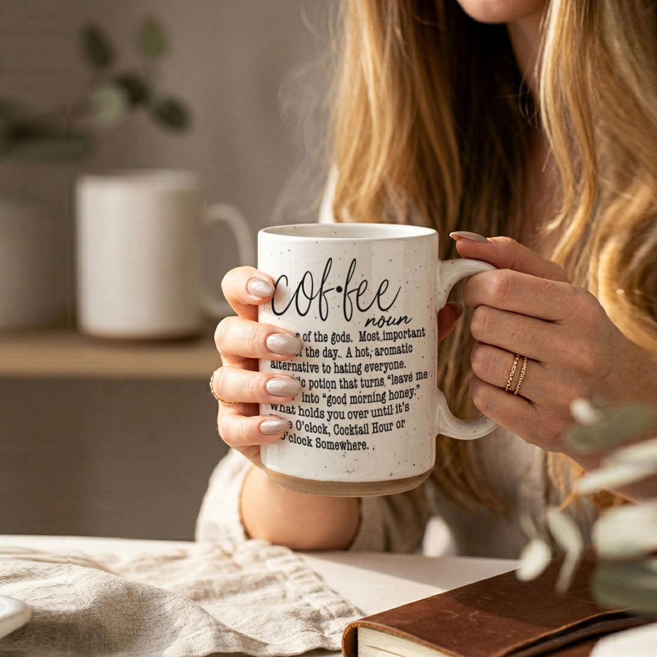 Gia Roma Coffee Def 16oz mug, white speckled with black script text, held by hands on Tampa Home & Garden Store