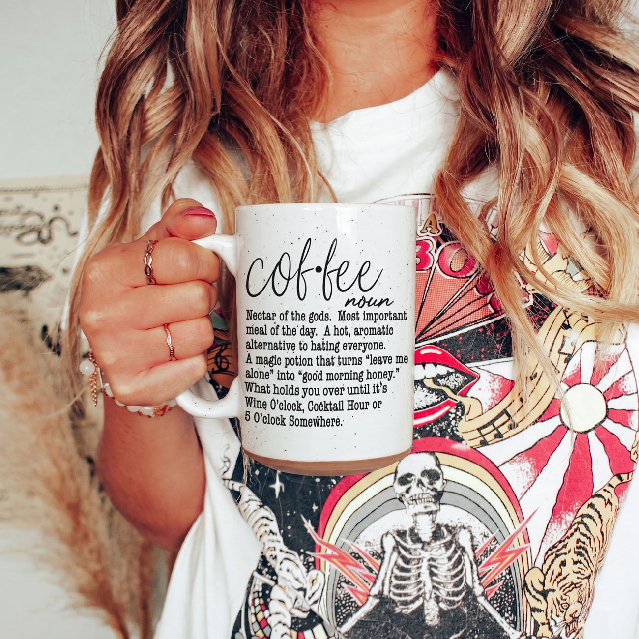 Coffee Def 16oz mug Gia Roma, white speckled ceramic with black script text, held by a woman on Tampa Home & Garden Store