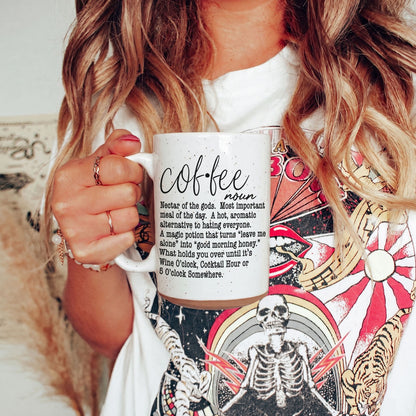 Coffee Def 16oz mug Gia Roma, white speckled ceramic with black script text, held by a woman on Tampa Home & Garden Store