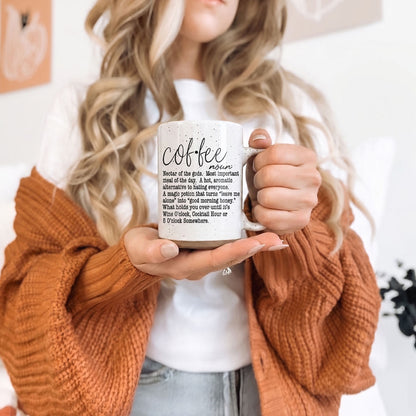 Coffee Def 16oz mug by Gia Roma, speckled ceramic with black coffee text, held in hand on Tampa Home & Garden Store