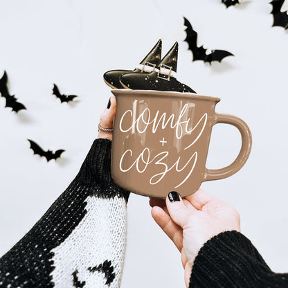 Gia Roma Comfy + Cozy mug taupe with white text and black shoes on rim on Tampa Home & Garden Store