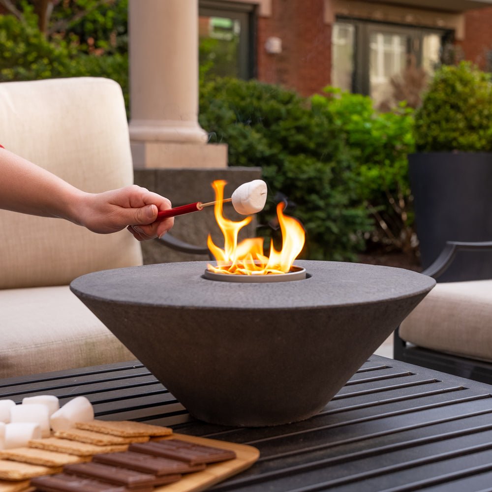 Concrete Cone Fire Pit City Bonfires outdoors with a marshmallow on a skewer over flames on Tampa Home & Garden Store