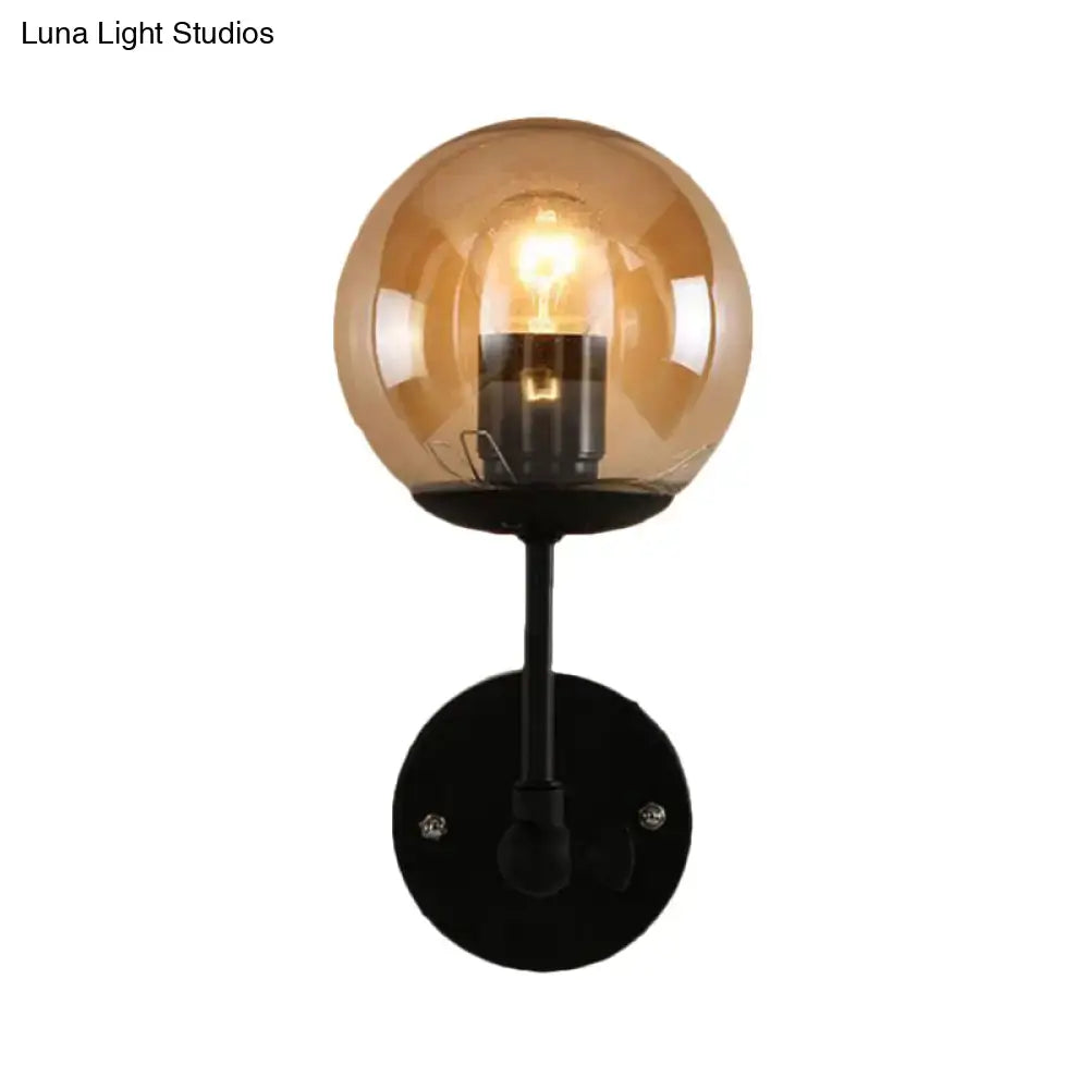 Black Amber Globe Sconce by Decorbites with amber glass globe and black metal mount on Tampa Home & Garden Store