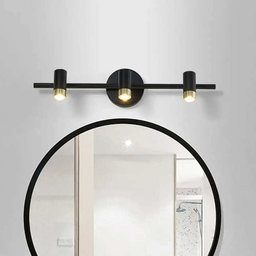 Black brass three-light vanity sconce with horizontal bar and round backplate by Decorbites on Tampa Home & Garden Store