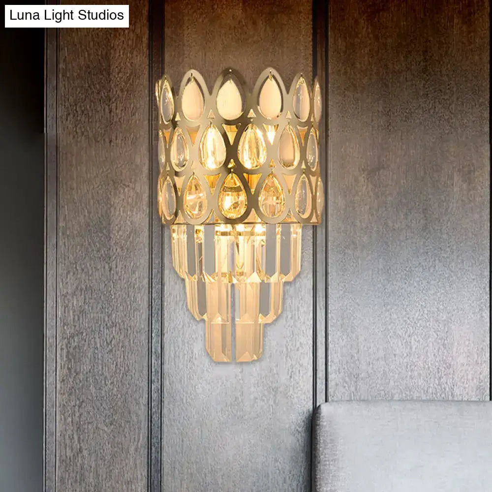 Black teardrop crystal sconce with gold-toned hanging prisms by Decorbites on wall on Tampa Home & Garden Store