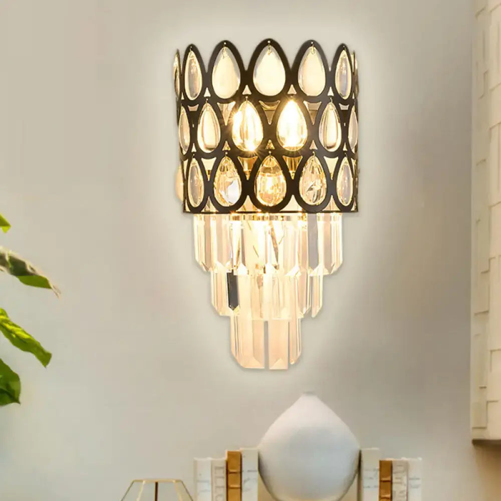 Black teardrop crystal sconce with black metal frame and hanging prisms on Tampa Home & Garden Store