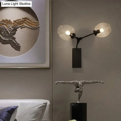 Black Gold Clear-Glass Wall Sconce with dual glass globes on a black metal mount on Tampa Home & Garden Store