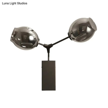 Dual-globe black-gold clear-glass wall sconce on black metal Y-arm with rectangular mount on Tampa Home & Garden Store