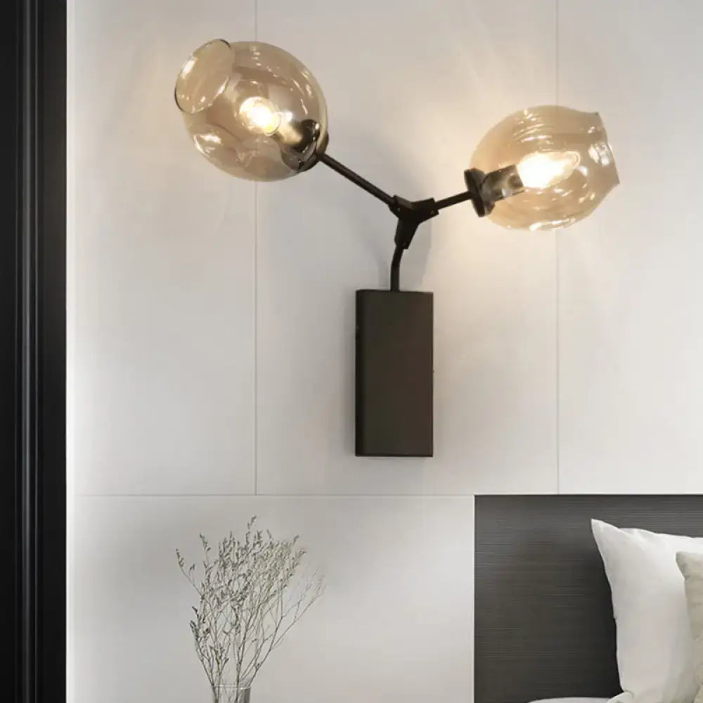 Black Gold Clear-Glass Wall Sconce with glass globes on black metal arms and backplate on Tampa Home & Garden Store