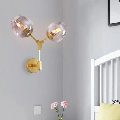 Decorbites black gold clear-glass wall sconce with two glass globes and dual brass arms on Tampa Home & Garden Store