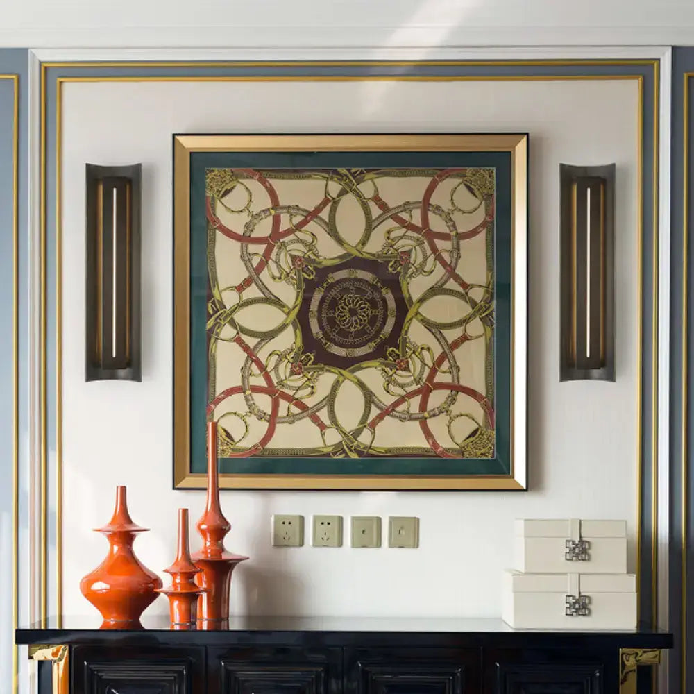 Black metal shade wall lamp pair flanks a framed ornate artwork on a decorative wall on Tampa Home & Garden Store