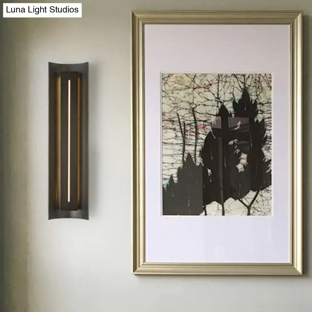 Black metal shade wall lamp by Decorbites, with a slim LED strip beside a gold art print on Tampa Home & Garden Store