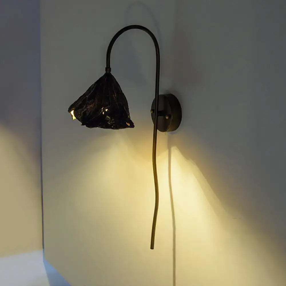 Black Lotus Leaf LED Wall Light by Decorbites, wall-mounted curved black arm with lotus shade, warm glow on Tampa Home & Garden Store
