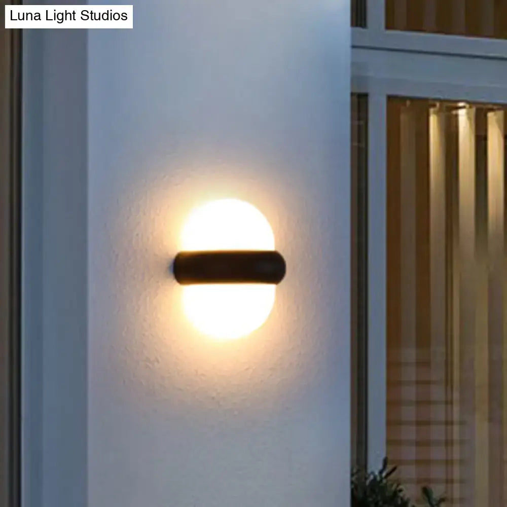 Decorbites black semi-sphere outdoor wall light mounted on white exterior wall near a window on Tampa Home & Garden Store
