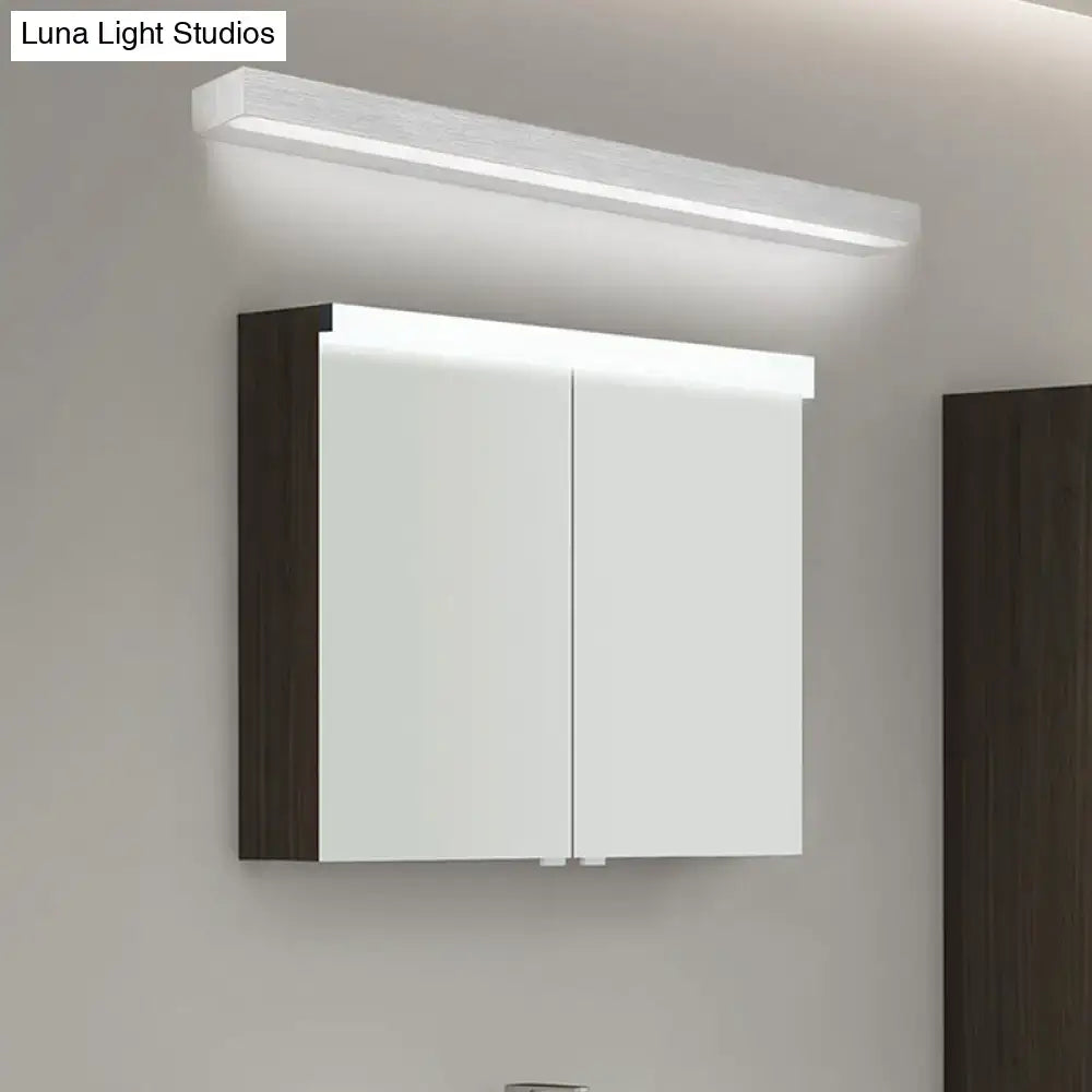 Contemporary black and silver linear vanity sconce with LED light above a mirrored cabinet on Tampa Home & Garden Store