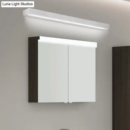 Contemporary black and silver linear vanity sconce with LED light above a mirrored cabinet on Tampa Home & Garden Store
