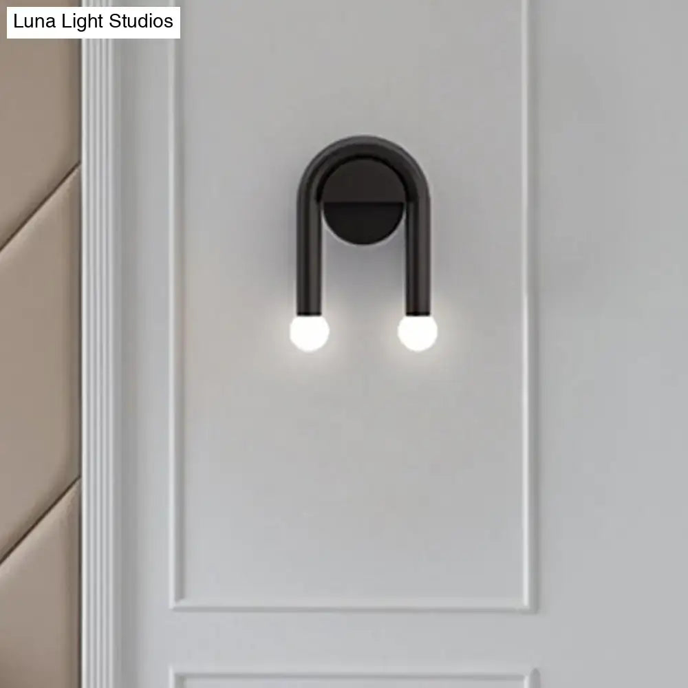 Black metal U-shaped wall light by Decorbites with dual glowing bulbs wall sconce on Tampa Home & Garden Store