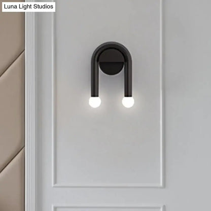 Black metal U-shaped wall light by Decorbites with dual glowing bulbs wall sconce on Tampa Home & Garden Store