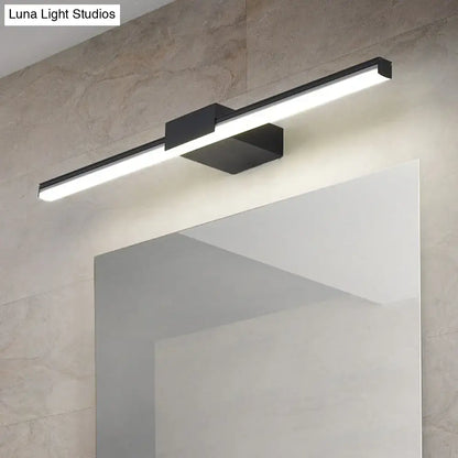 Black linear wall light fixture with white LED bar by Decorbites above a mirror on Tampa Home & Garden Store
