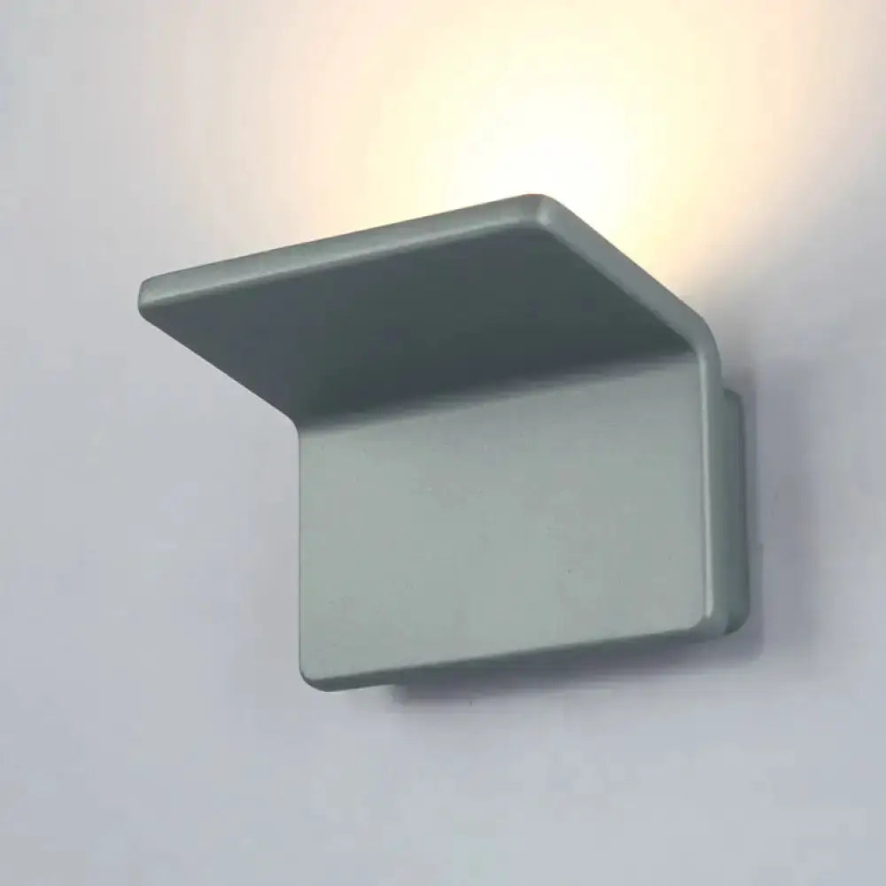 Contemporary gray LED wall lamp with rectangular base and upward angled shade on Tampa Home & Garden Store
